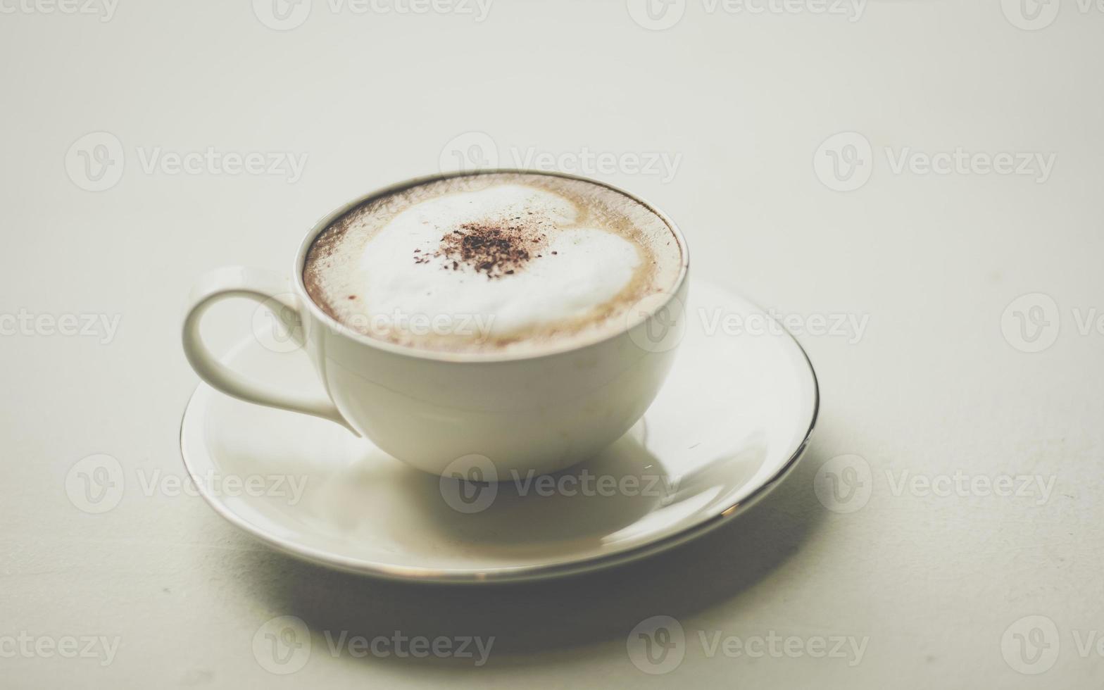 Coffee cup with hearts on old table photo