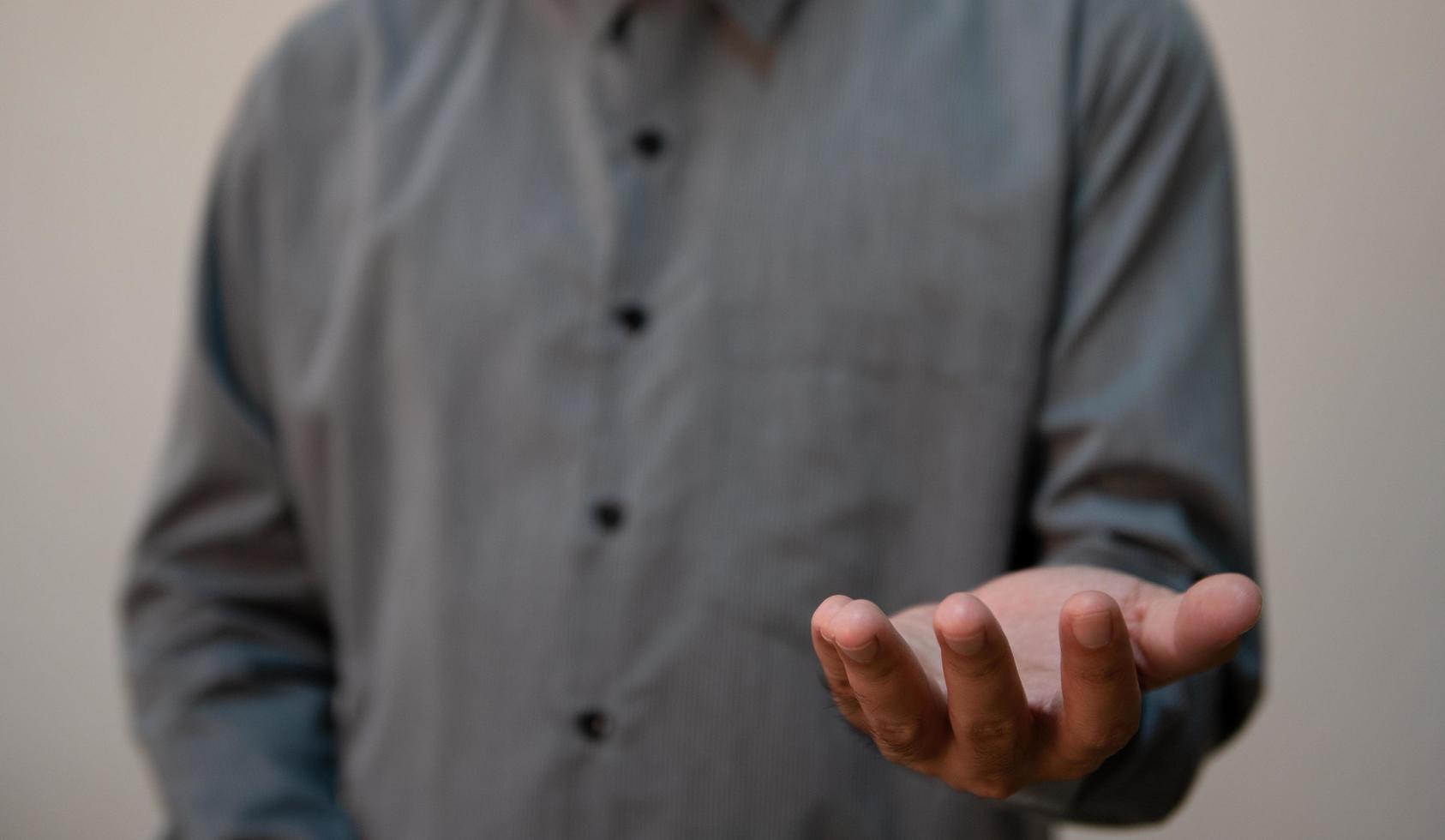 Young handsome man wearing light blue shirt with different behaviors at work photo