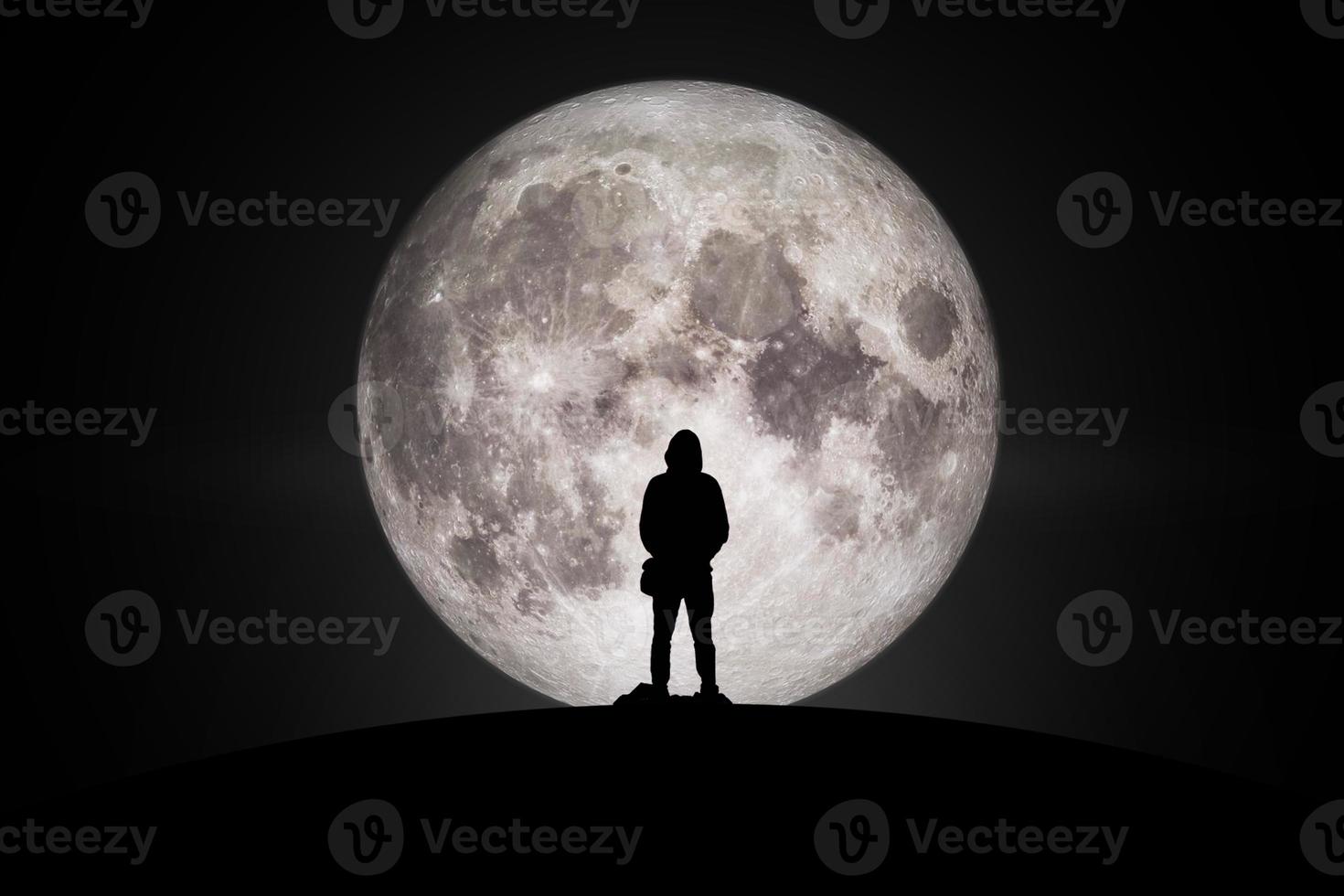Silhouette of man  Looking at the moon with hope Fulfillment in love. Elements of this image furnished by NASA. photo