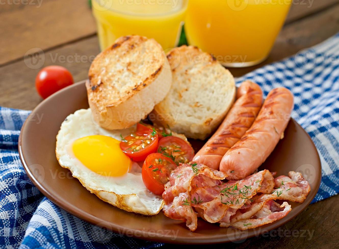 English breakfast - toast, egg, bacon and vegetables in a rustic style on wooden background photo