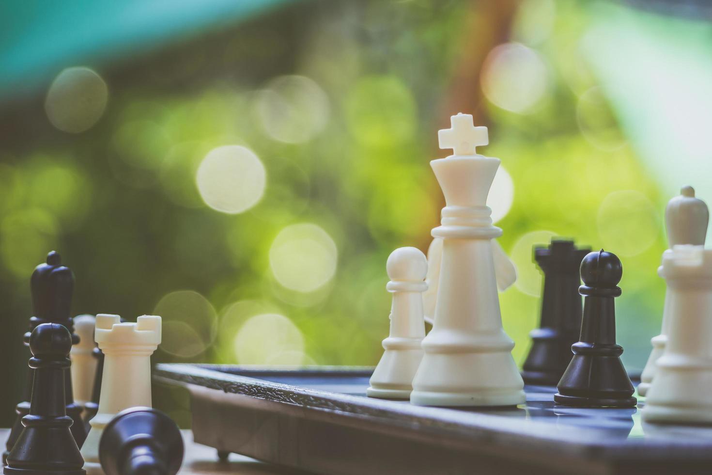 Black and White King and Knight of chess battle on board . Black king are leader to fight with teamwork to victory. Leader and teamwork concept for success. Competition and defeating concept photo