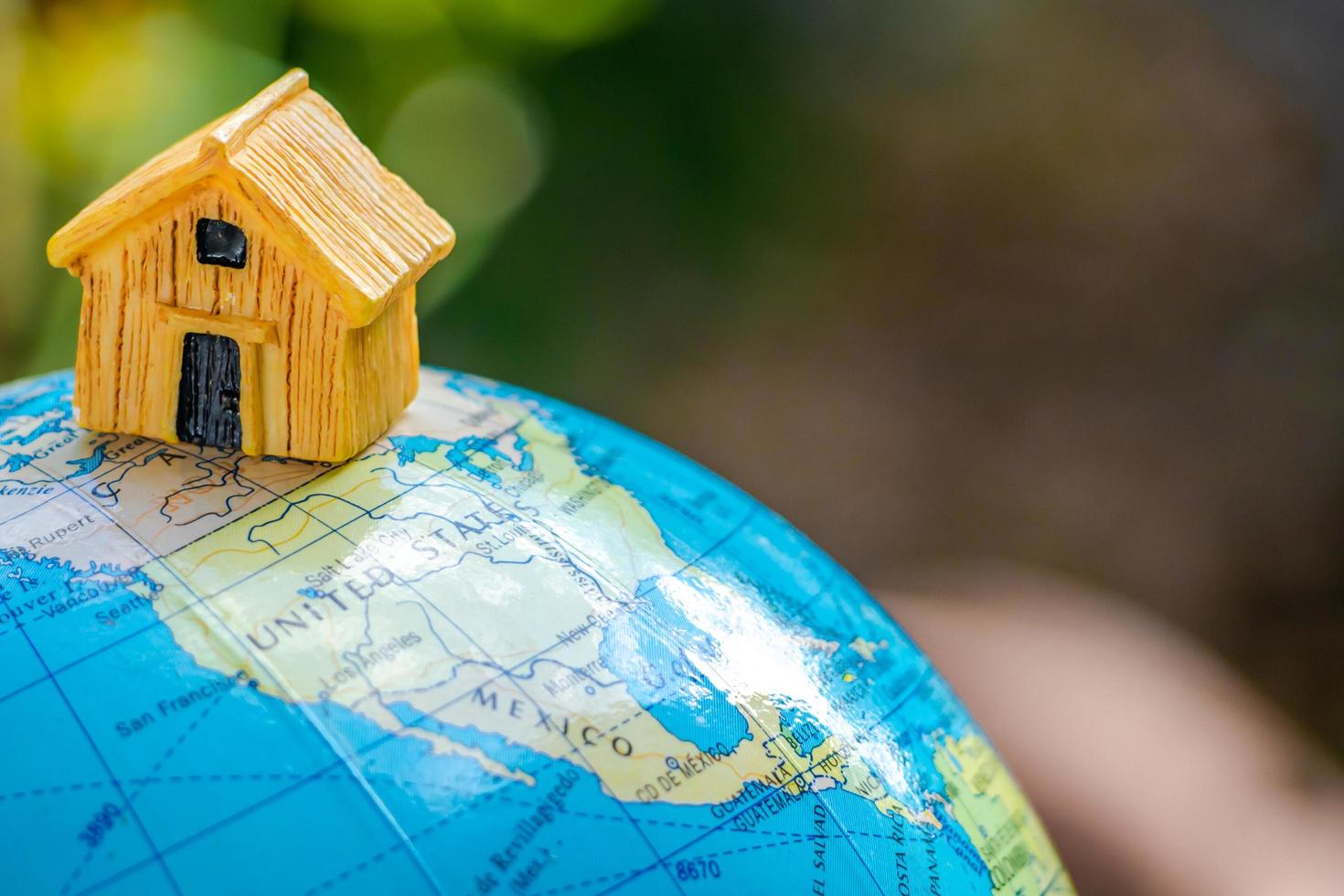 House or Home model with communication on globe model. Concept for loan, property ladder, financial, mortgage, real estate investment, taxes and bonus. Communication and network concept. photo