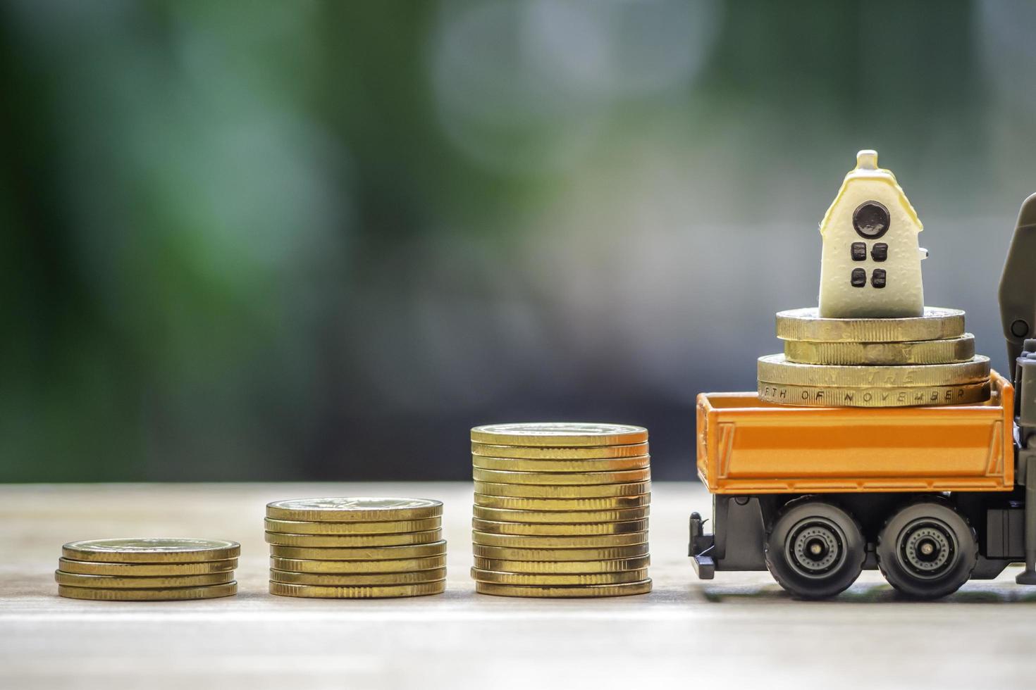 House or Home model on top of coins stack. Concept for loan, property ladder, financial, mortgage, real estate investment, taxes and bonus. photo