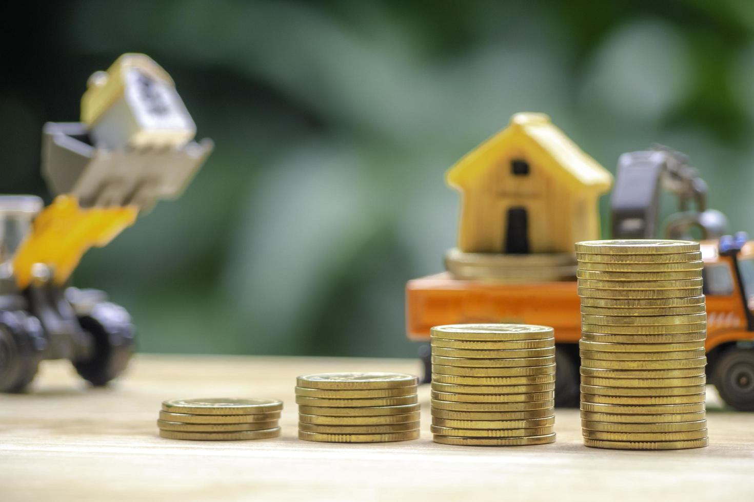 House or Home model on top of coins stack. Concept for loan, property ladder, financial, mortgage, real estate investment, taxes and bonus. photo