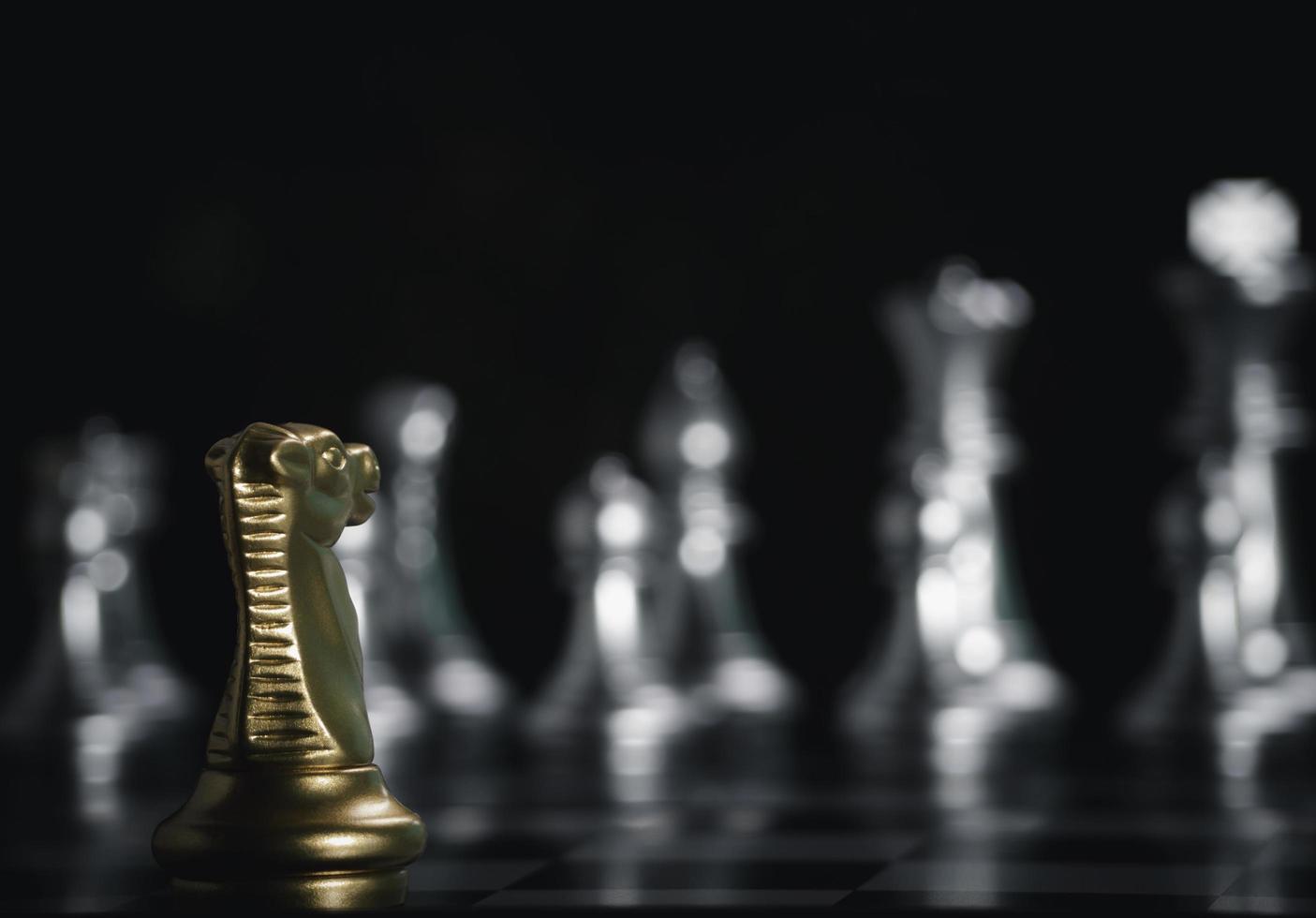 Golden knight chess pieces facing in front silver chess on board with flare light to successfully in the competition. Management or leadership strategy and teamwork concept. photo