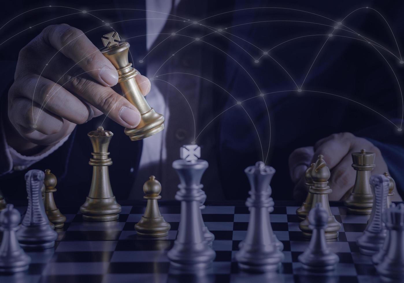 Hand of businessman holding gold king chess on stock market or forex trading graph chart with cityscape image economy trend for digital financial investment.Management or leadership strategy concept. photo