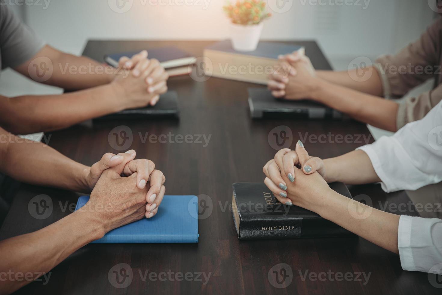 christian concept Put your hands on the Bible and pray to God. Study the Bible together. Live life. Praying together. Combining the power of hope or love and loyalty. photo