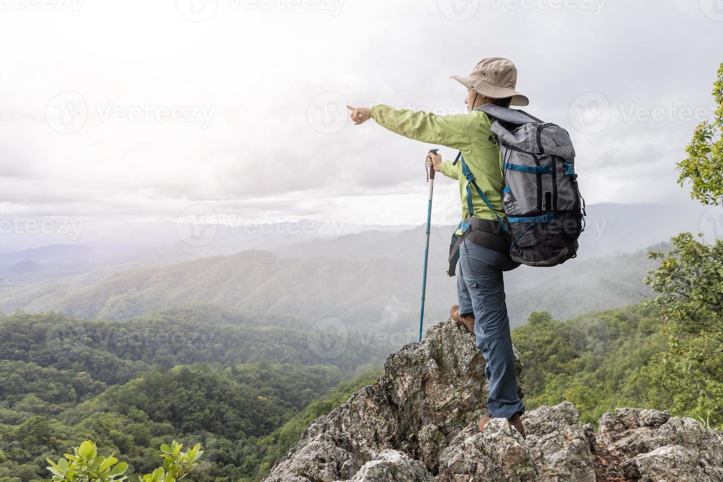 Hikers relax on top of a hill with beautiful views. photo