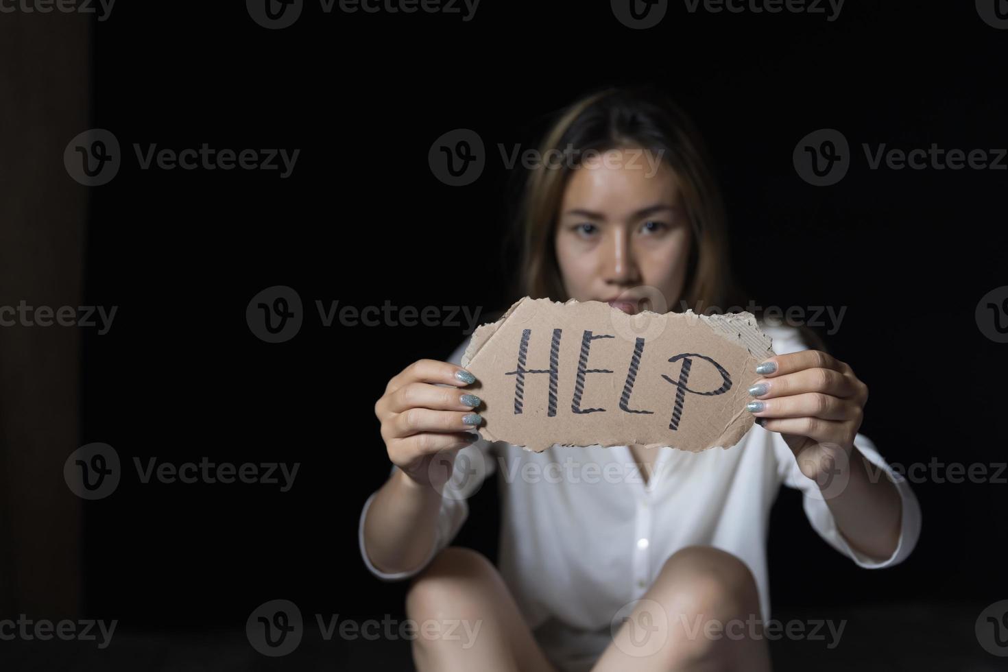 Shea woman holding a sign with get help, concept stop violence and sexual harassment photo