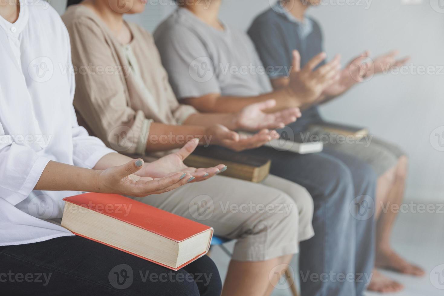 Asian Christian groups sitting within the Church Catholic prayed for blessings from God. A pale sun shone in a place of worship.Religious concepts. photo