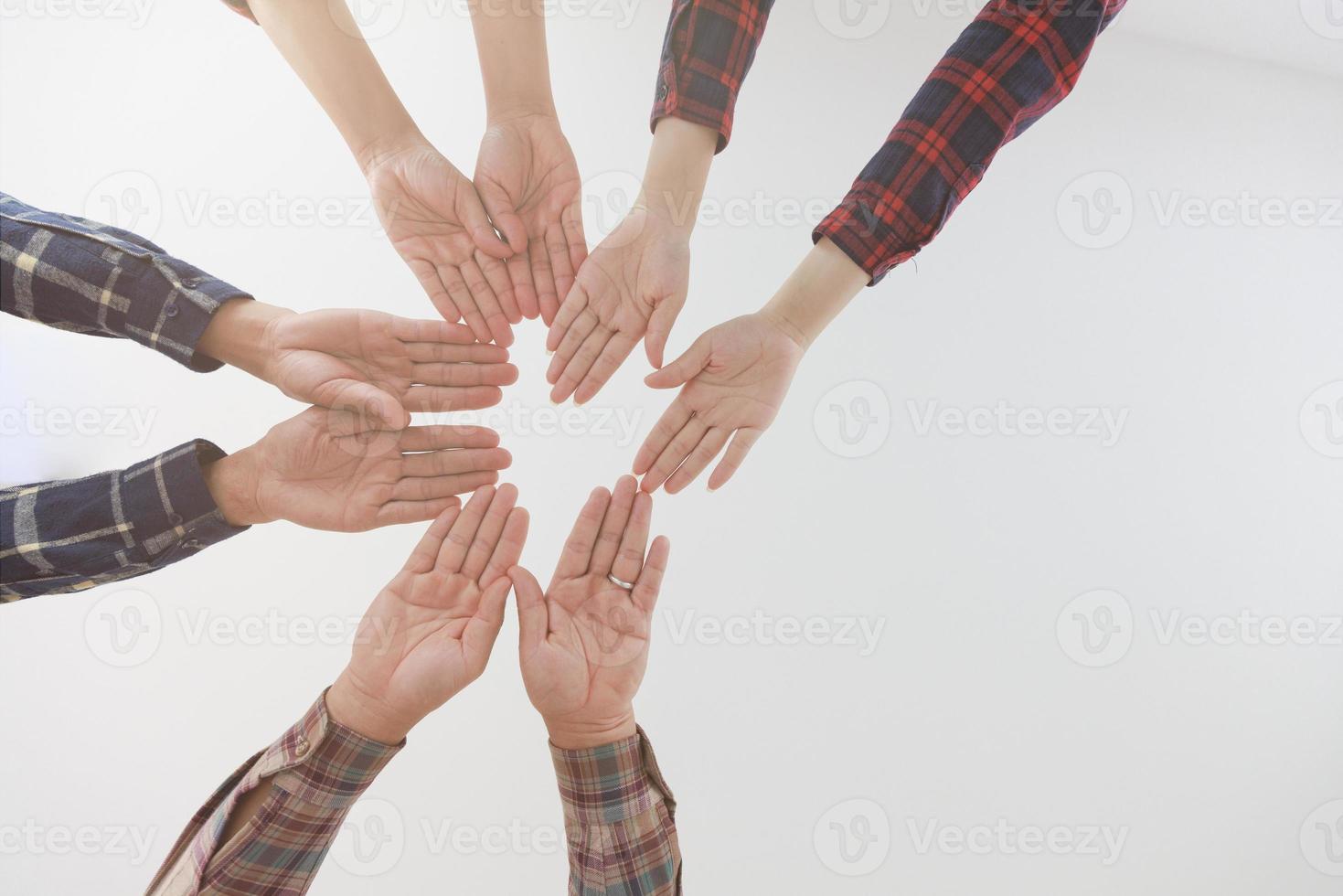 Young businessmen put their hands together, Working as a team together supports a common idea. photo