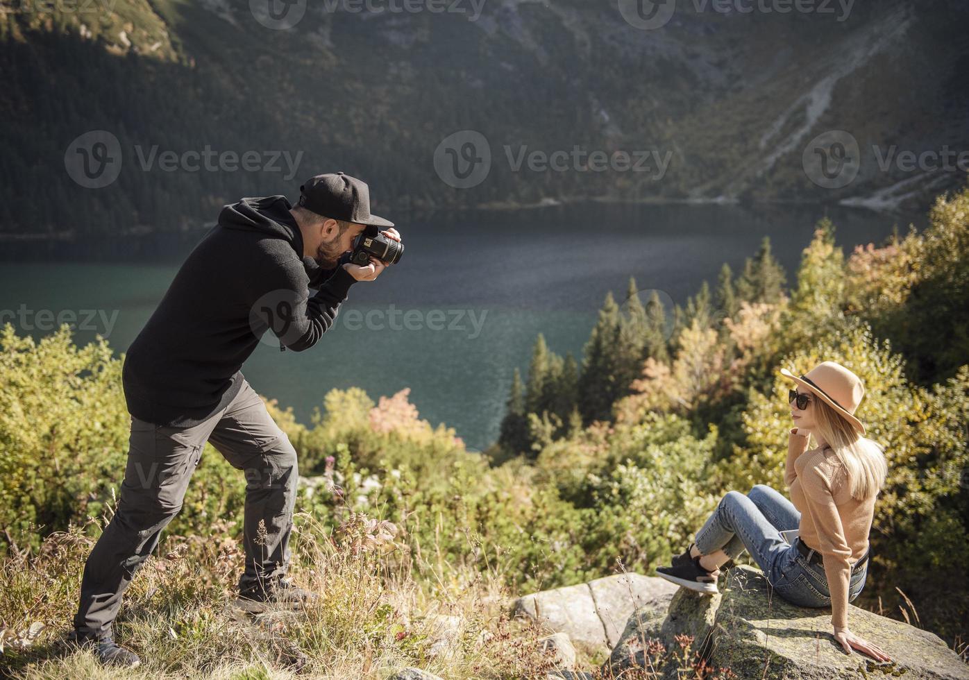 Beautiful woman smiling to her boyfriend camera while they traveling photo