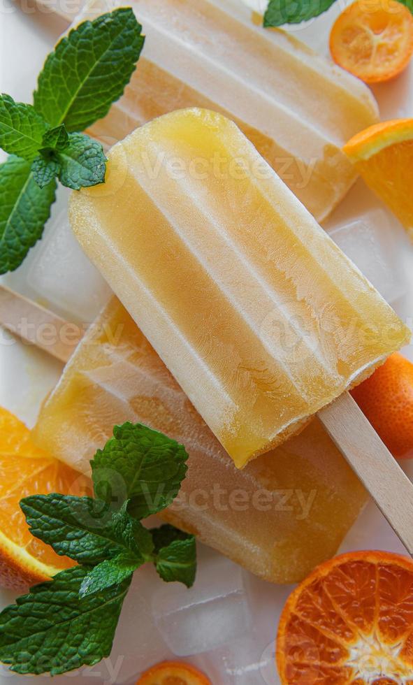 Natural juicy orange popsicles. photo