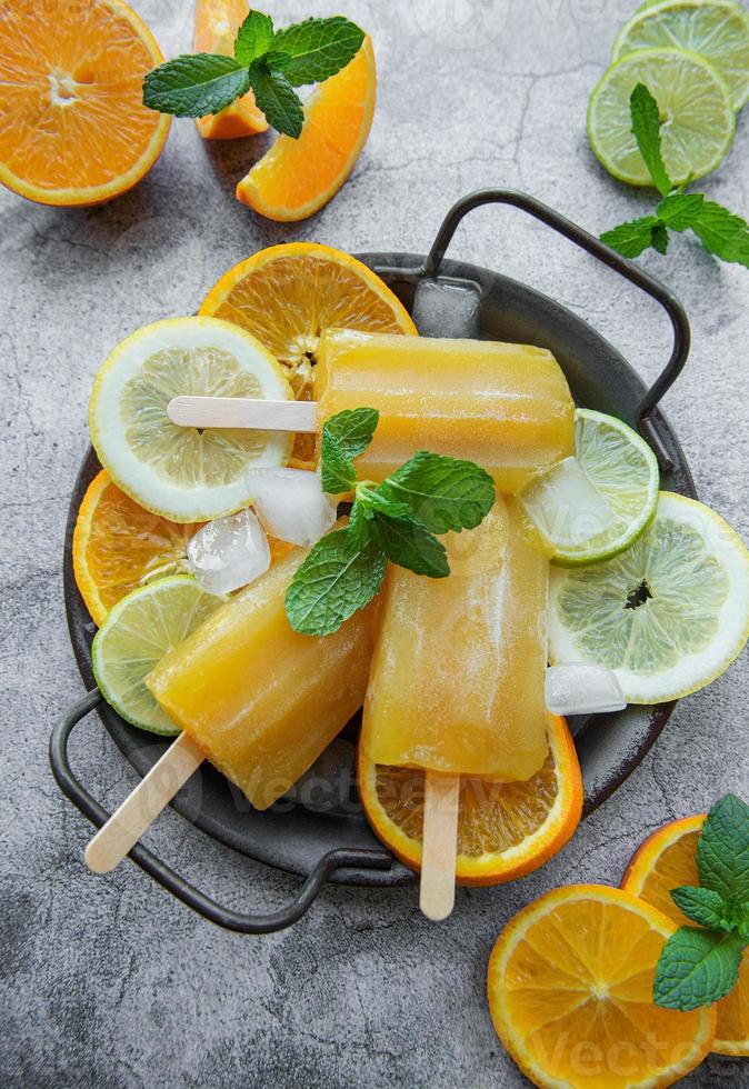 Natural juicy orange popsicles. photo