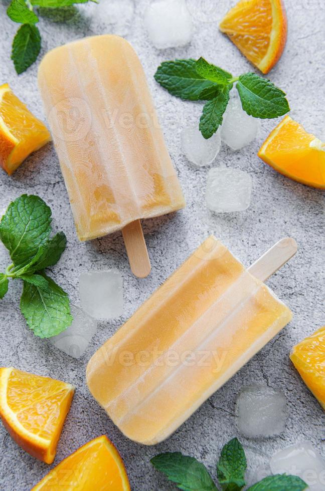 Natural juicy orange popsicles. photo