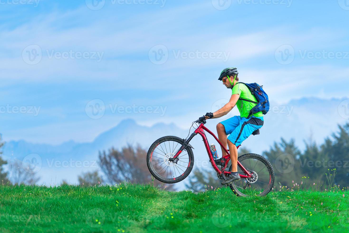 A young male riding a mountain bike photo