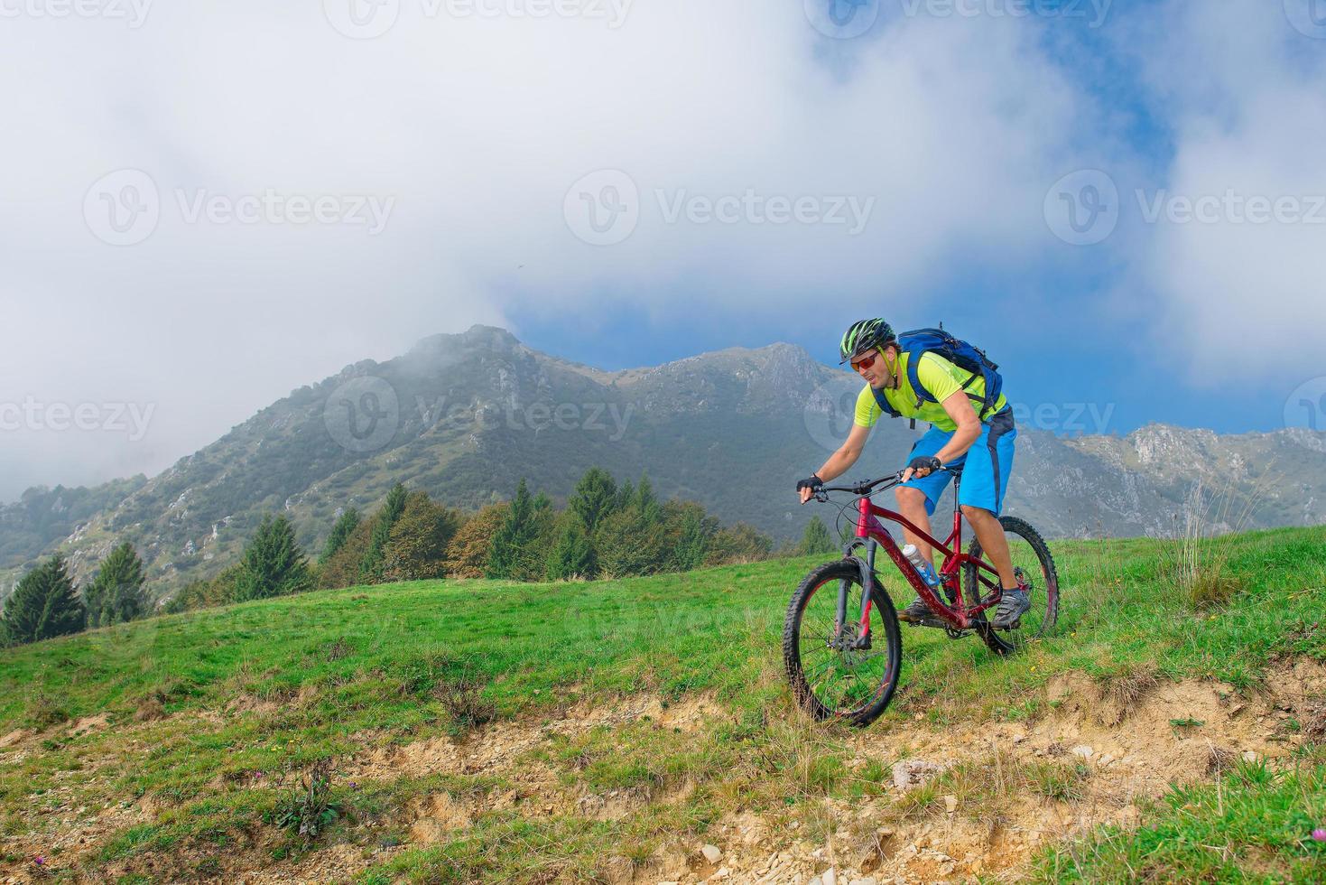 A young male riding a mountain bike outdoor photo