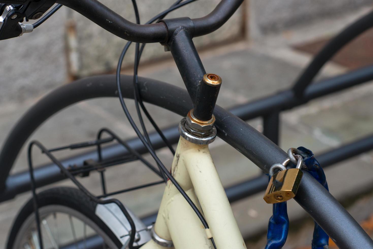 Bicycle tied by padlock photo