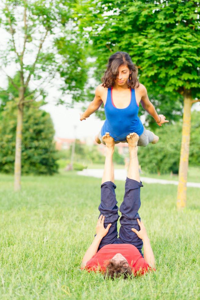 Couple practicing acroyoga in the park photo