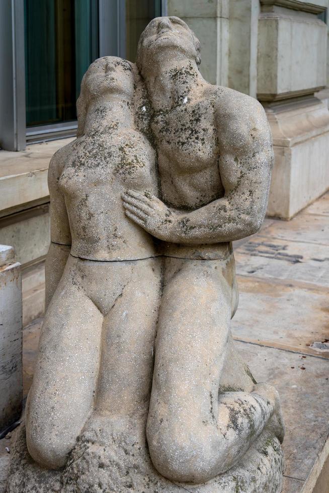 Statue of two lovers outside the Palace of the People building in Bucharest Romania on September 21, 2018 photo