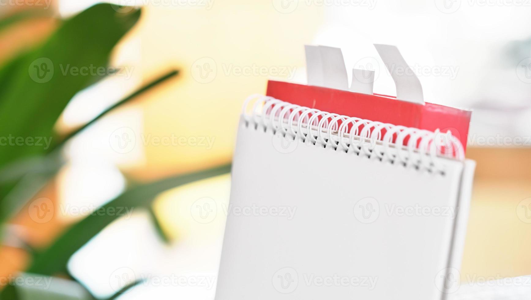 spiral notepad and book with bookmarks in living room, close up view. copy space for text message, blank sheet. photo