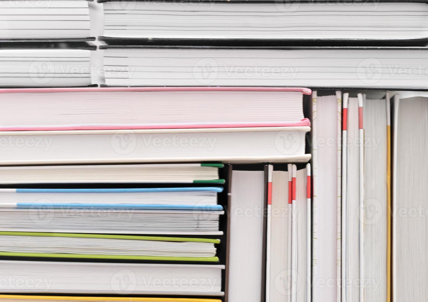 books stacked in a pattern. background for back to school concept. pile of hardcovered books photo