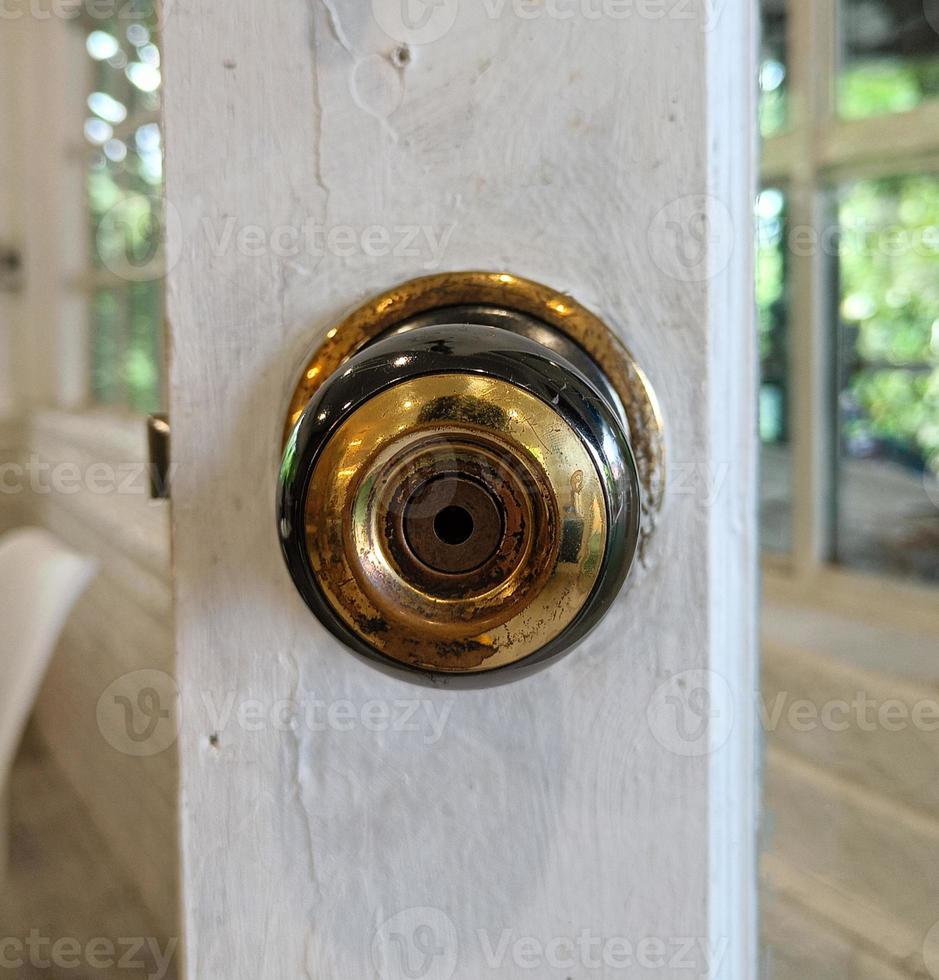 white wooden door, old gold stainless door knob photo