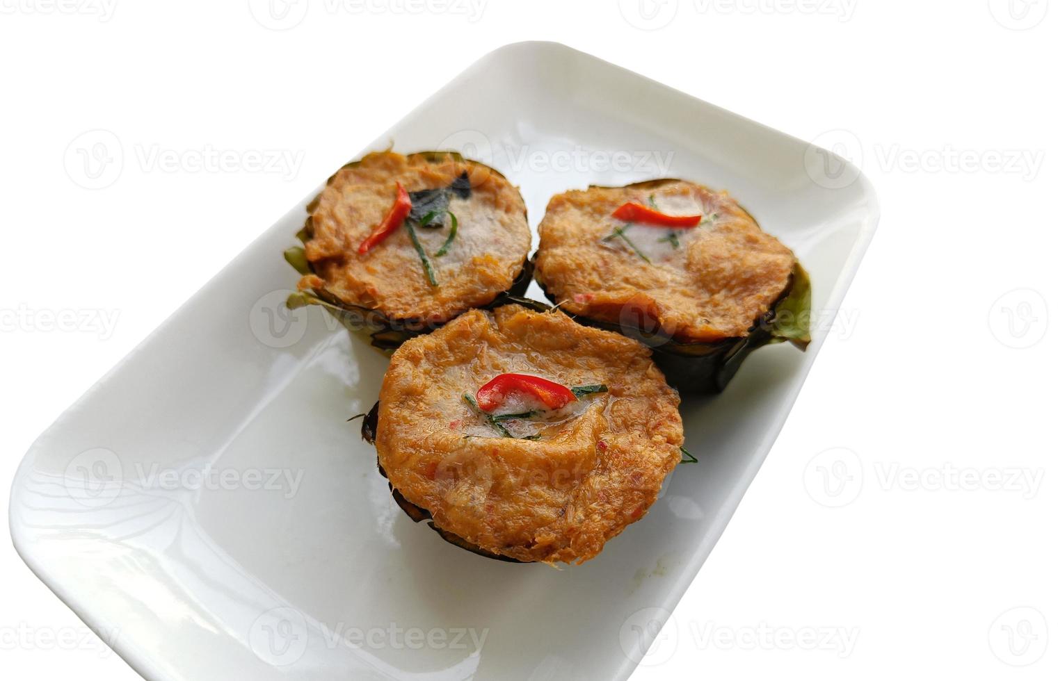 Thai steamed fish with curry paste Ho mok on white plate, isolated on white background with clipping path photo