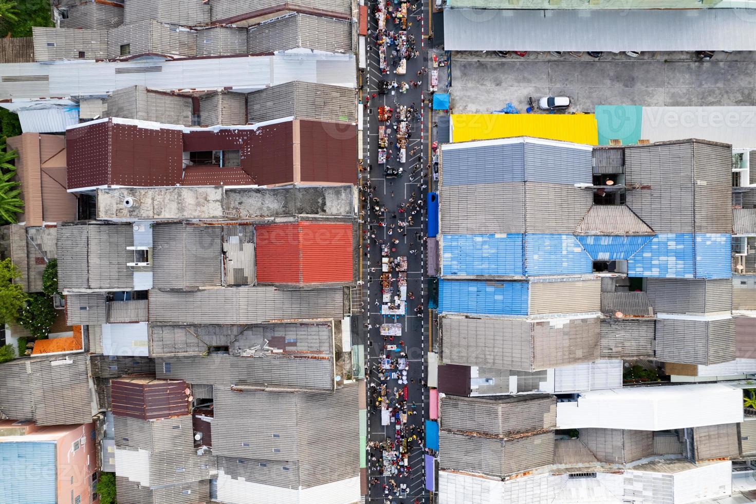 Aerial view Drone flying over phuket city Thailand.Drone over a street night market in Sunday at Phuket Town and Tourists walking shopping at old street full of local vendors selling Food and Clothes photo