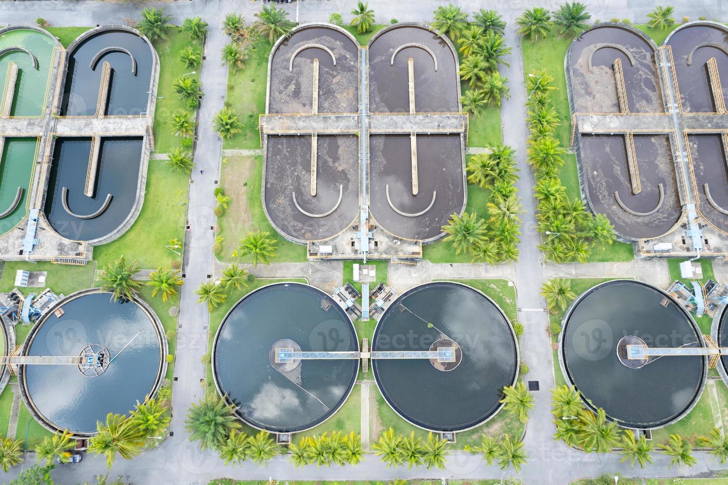 Aerial view High angle view Top down drone shot of the sewage treatment plant.The Solid contact clarifier tank type sludge recirculation in water treatment plant. Industrial wastewater treatment plant photo