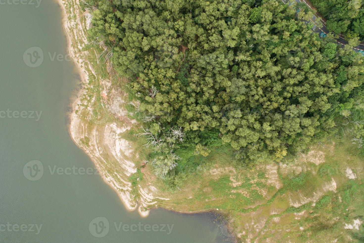 Top down of Dam lake mountains with forest green pattern beautiful sunny day summer weather Drone shot aerial view clouds irrigation Nature environment. photo