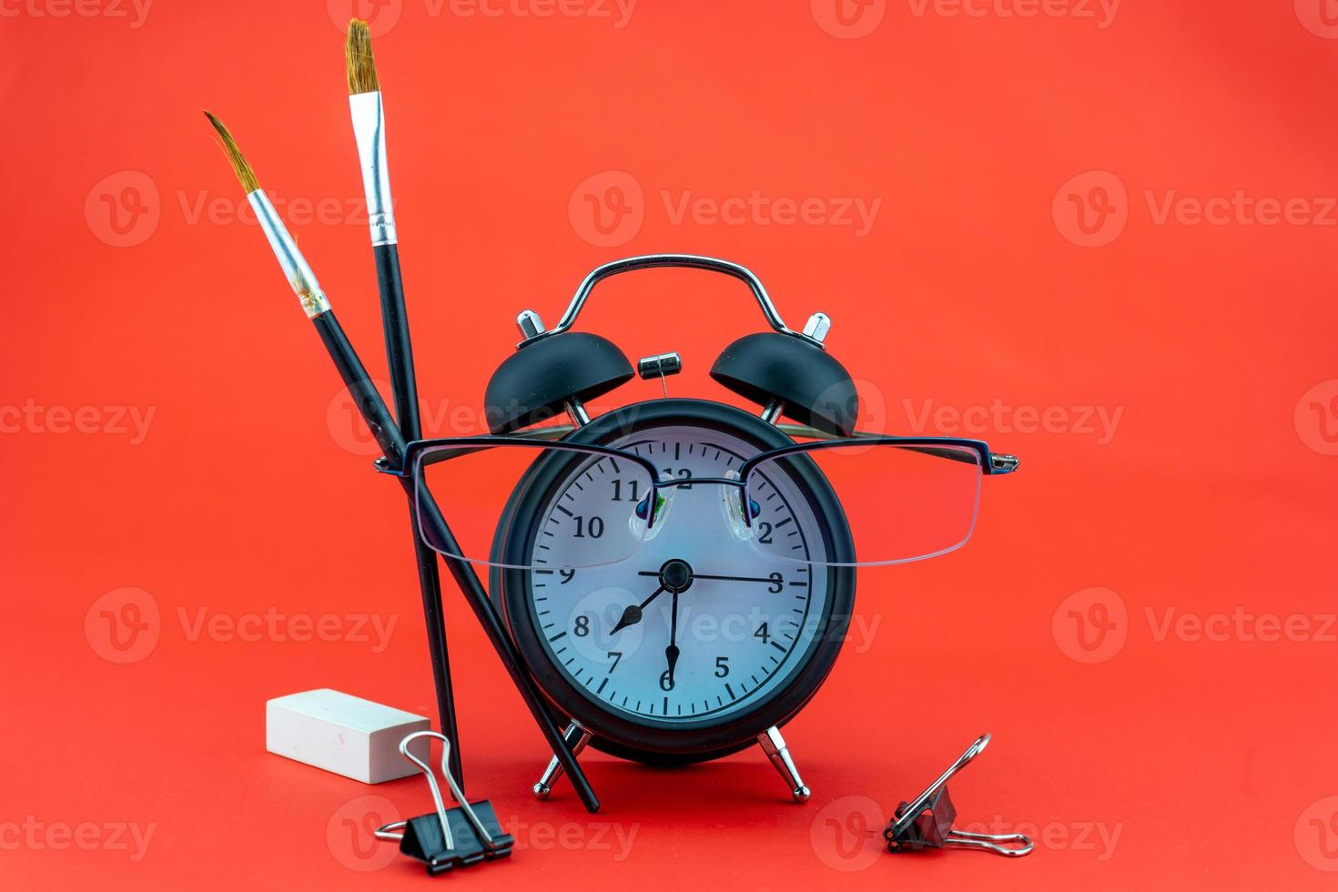 Concept Education or business Alarm clock and teacher glasses Business objects isolated on colorful background Back to school concept photo