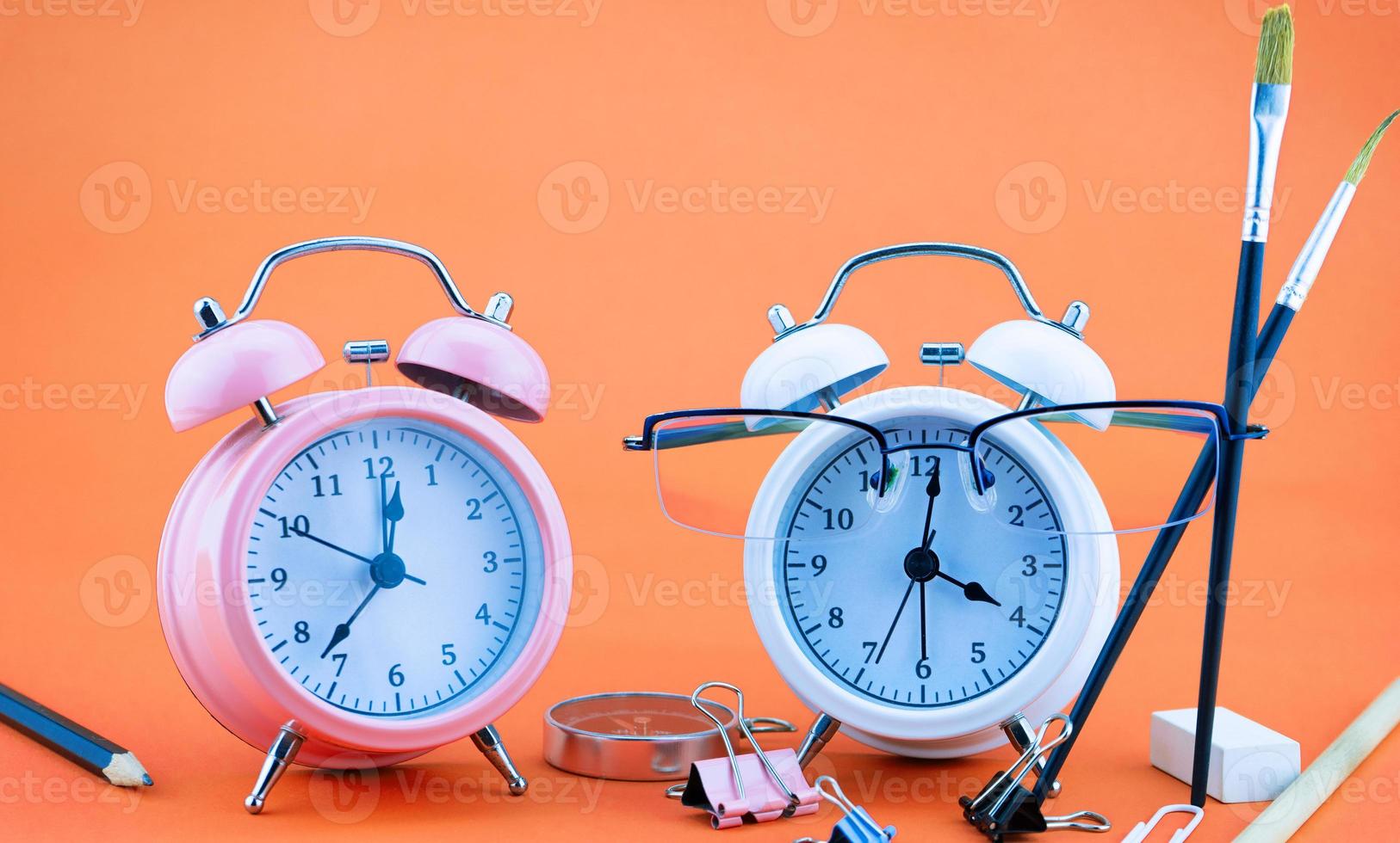 Concept Education or business Alarm clock and teacher glasses Business objects isolated on colorful background Back to school concept photo