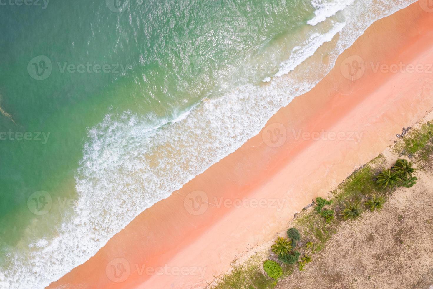 Aerial view sandy beach and waves Beautiful tropical sea in the morning summer season image by Aerial view drone shot, high angle view Top down sea waves in summer season photo