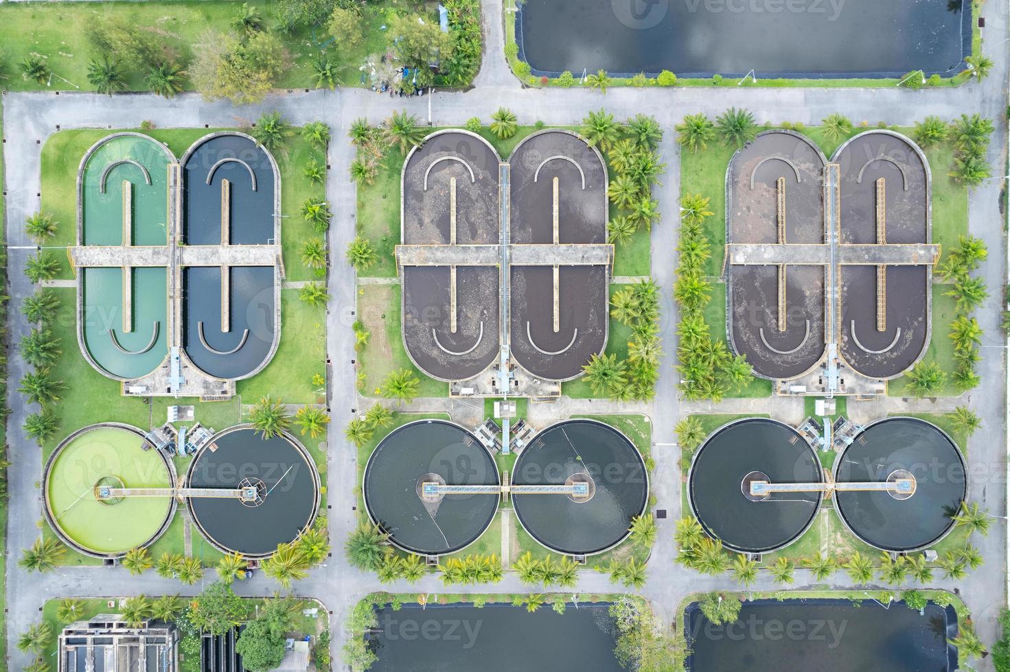 Aerial view High angle view Top down drone shot of the sewage treatment plant.The Solid contact clarifier tank type sludge recirculation in water treatment plant. Industrial wastewater treatment plant photo