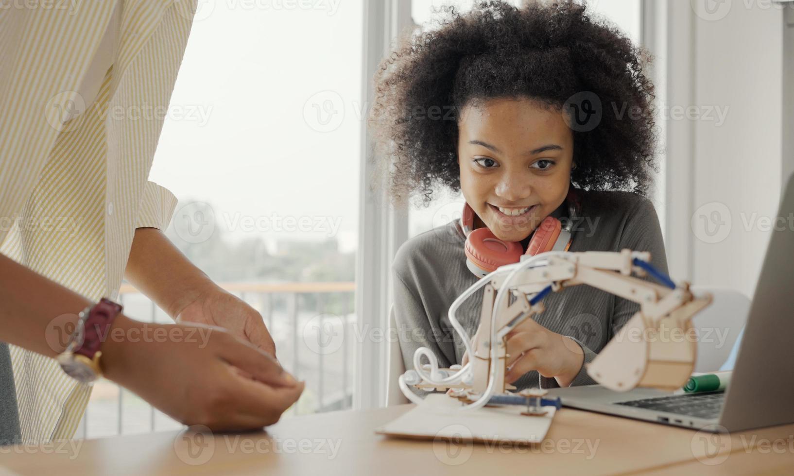 Classroom with diverse learners of happily African American students and teacher doing activities together. The teacher is teaching, guiding and talking to the children in diverse. photo