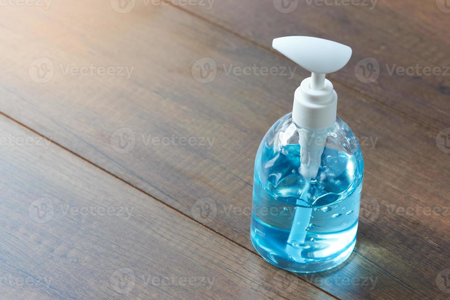 A bottle of hand sanitizer on wooden background photo