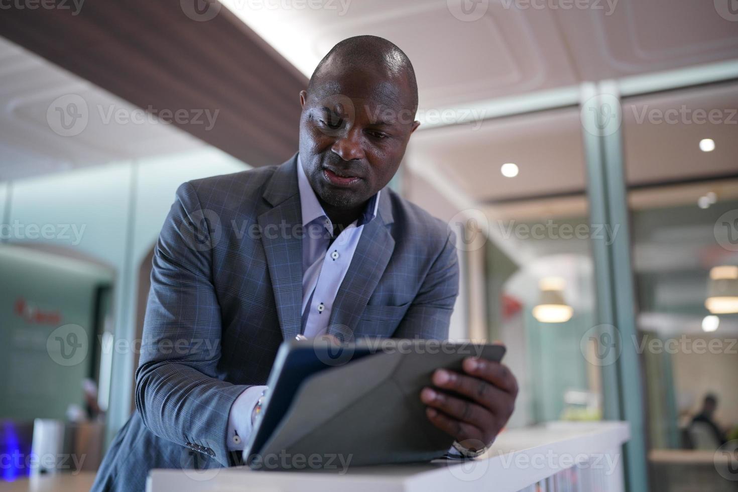 African American Entrepreneur and collaborating with coworkers over network internet 5G technology. photo