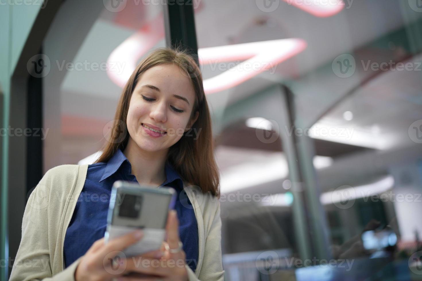 Young attractive female using a mobile phone for social media and using new online 5G technology app photo