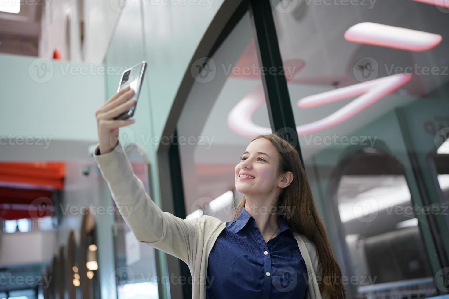 Young attractive female using a mobile phone for social media and using new online 5G technology app photo