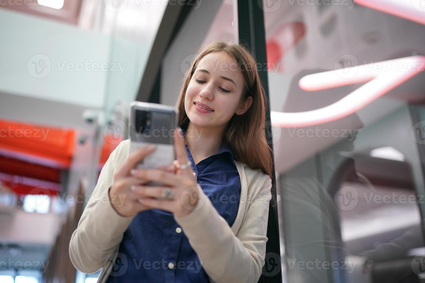 Young attractive female using a mobile phone for social media and using new online 5G technology app photo
