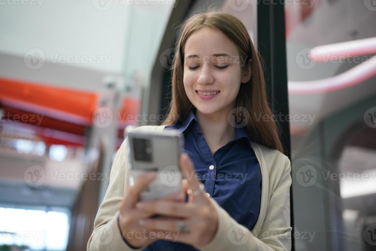 Young attractive female using a mobile phone for social media and using new online 5G technology app photo