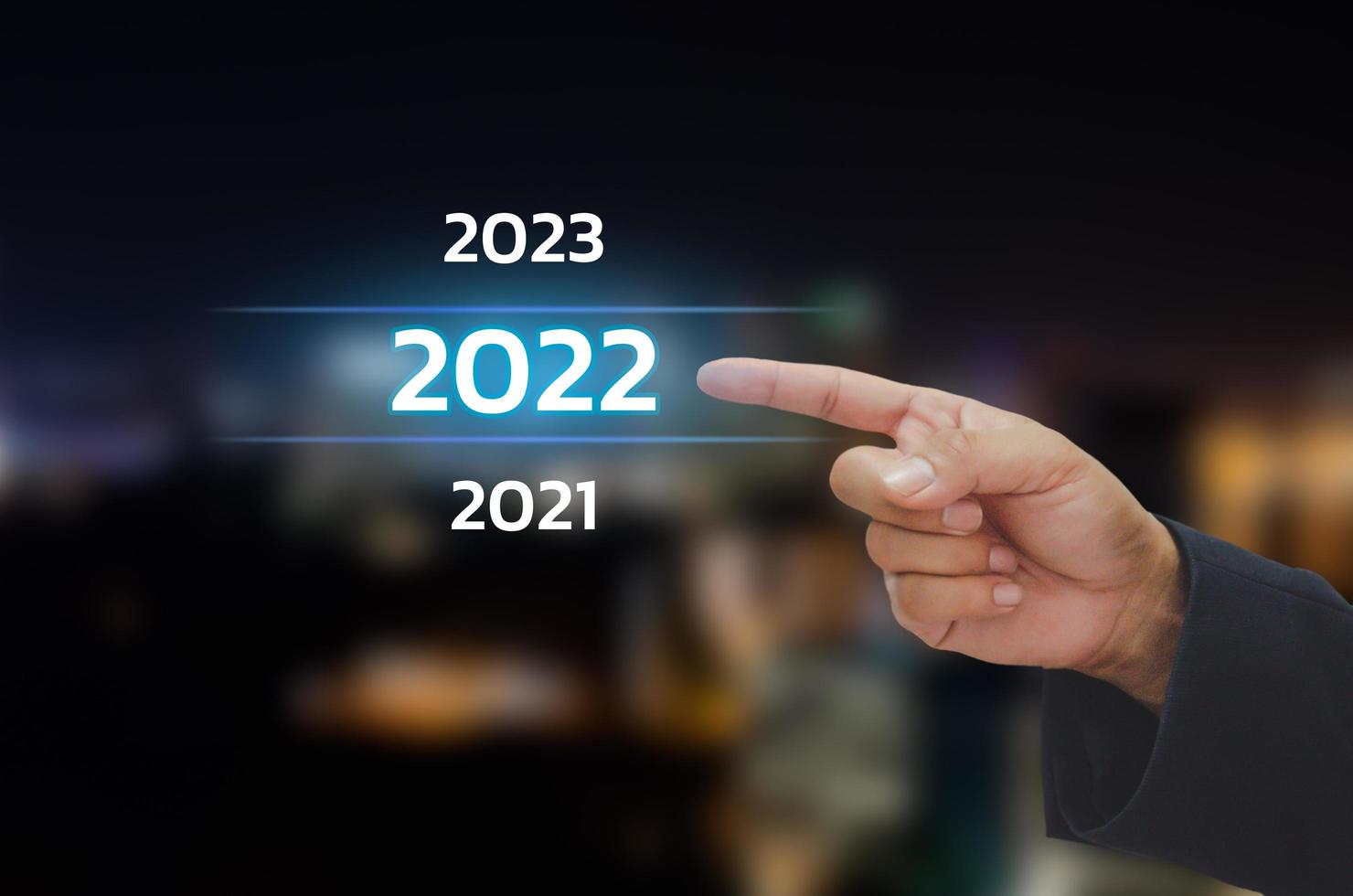 mano de hombre de negocios tocando el número de año 2022 en el concepto de pantalla virtual tendencias digitales, tendencia de la industria y los negocios. copie el espacio foto