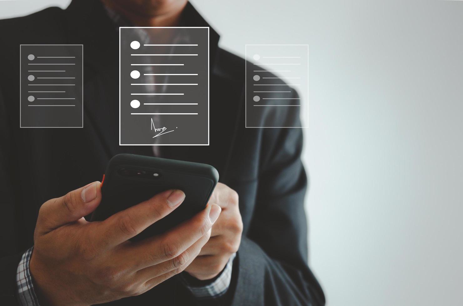 businessman holding smartphone business digital signing documents on virtual screen. photo