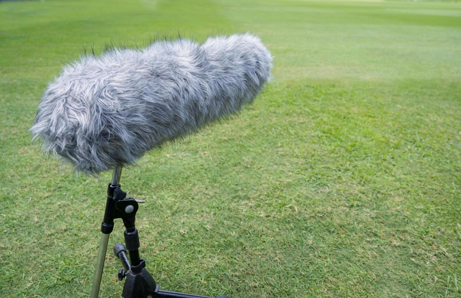 The long gun microphone on the soccer field, microphone for live events, Recording devices is placed around the football field to provide full sound. photo