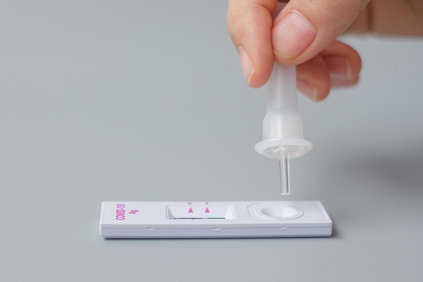 man swab COVID-19 testing by Rapid Antigen Test kit. Coronavirus Self nasal or Home test, Lockdown and Home Isolation concept photo