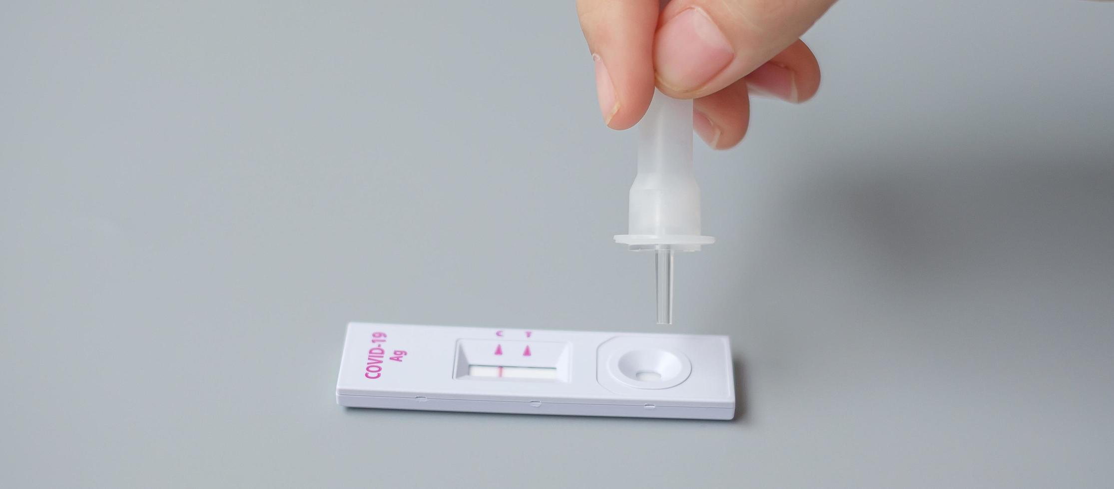 man swab COVID-19 testing by Rapid Antigen Test kit. Coronavirus Self nasal or Home test, Lockdown and Home Isolation concept photo