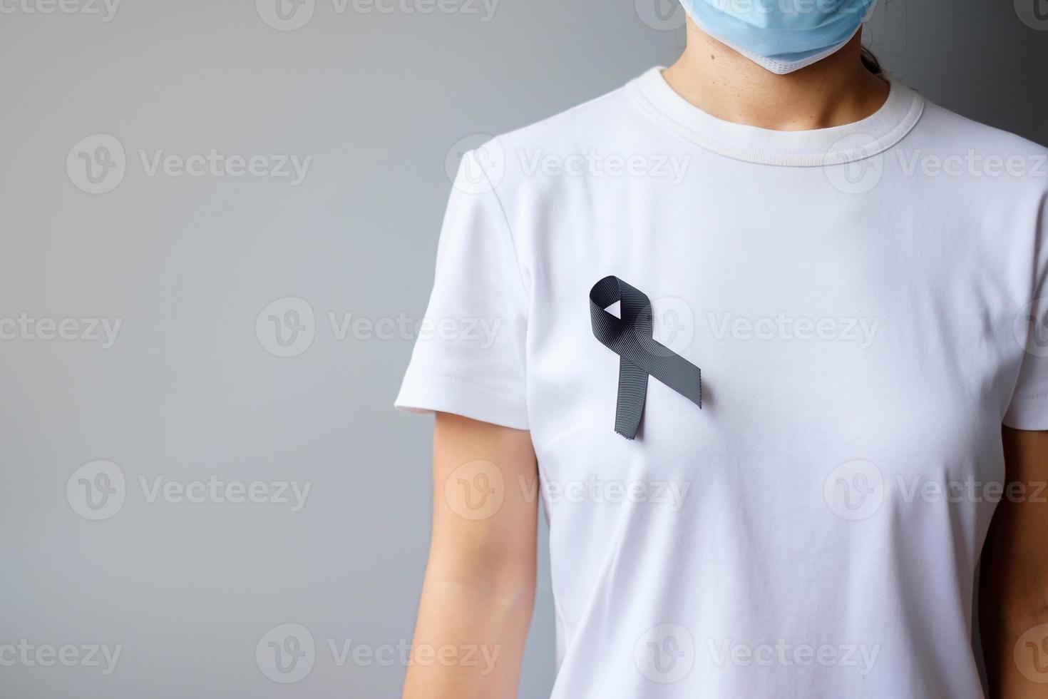 black Ribbon for Melanoma and skin cancer, Vaccine injury awareness month, grief and rest in peace. Healthcare and Racist concept photo