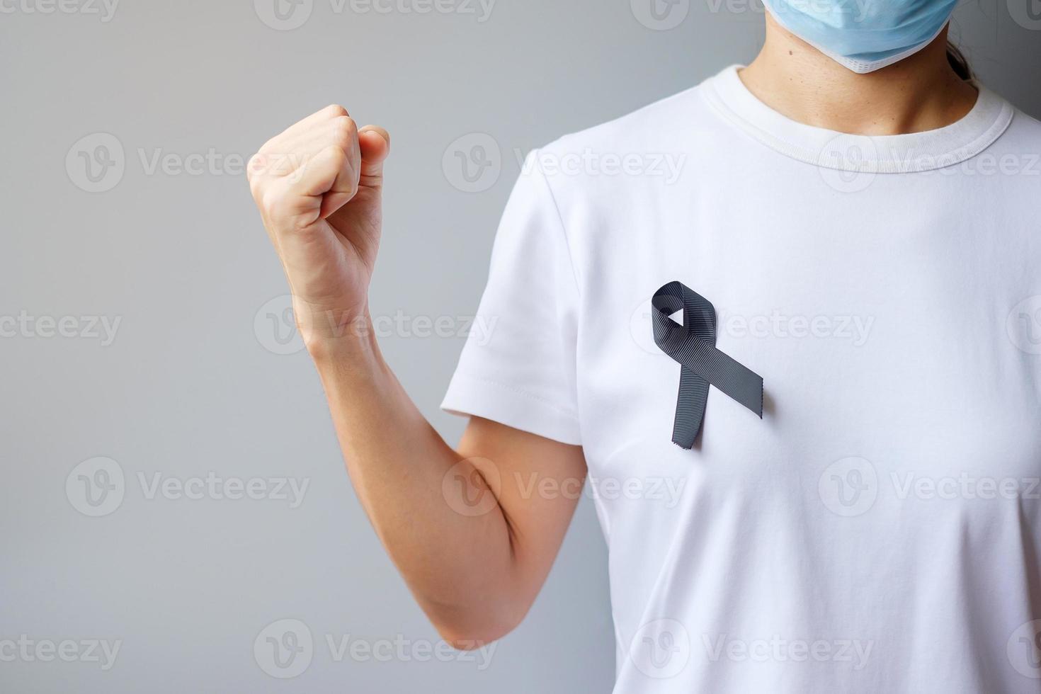 black Ribbon for Melanoma and skin cancer, Vaccine injury awareness month, grief and rest in peace. Healthcare and Racist concept photo