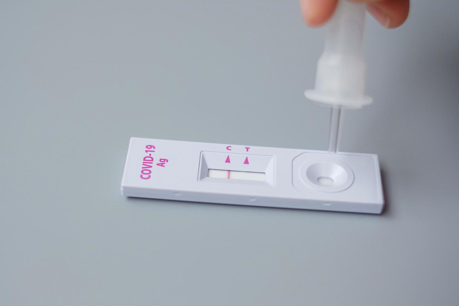 man swab COVID-19 testing by Rapid Antigen Test kit. Coronavirus Self nasal or Home test, Lockdown and Home Isolation concept photo